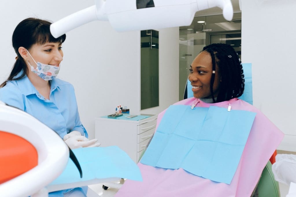 dentist and patient smiling at each other